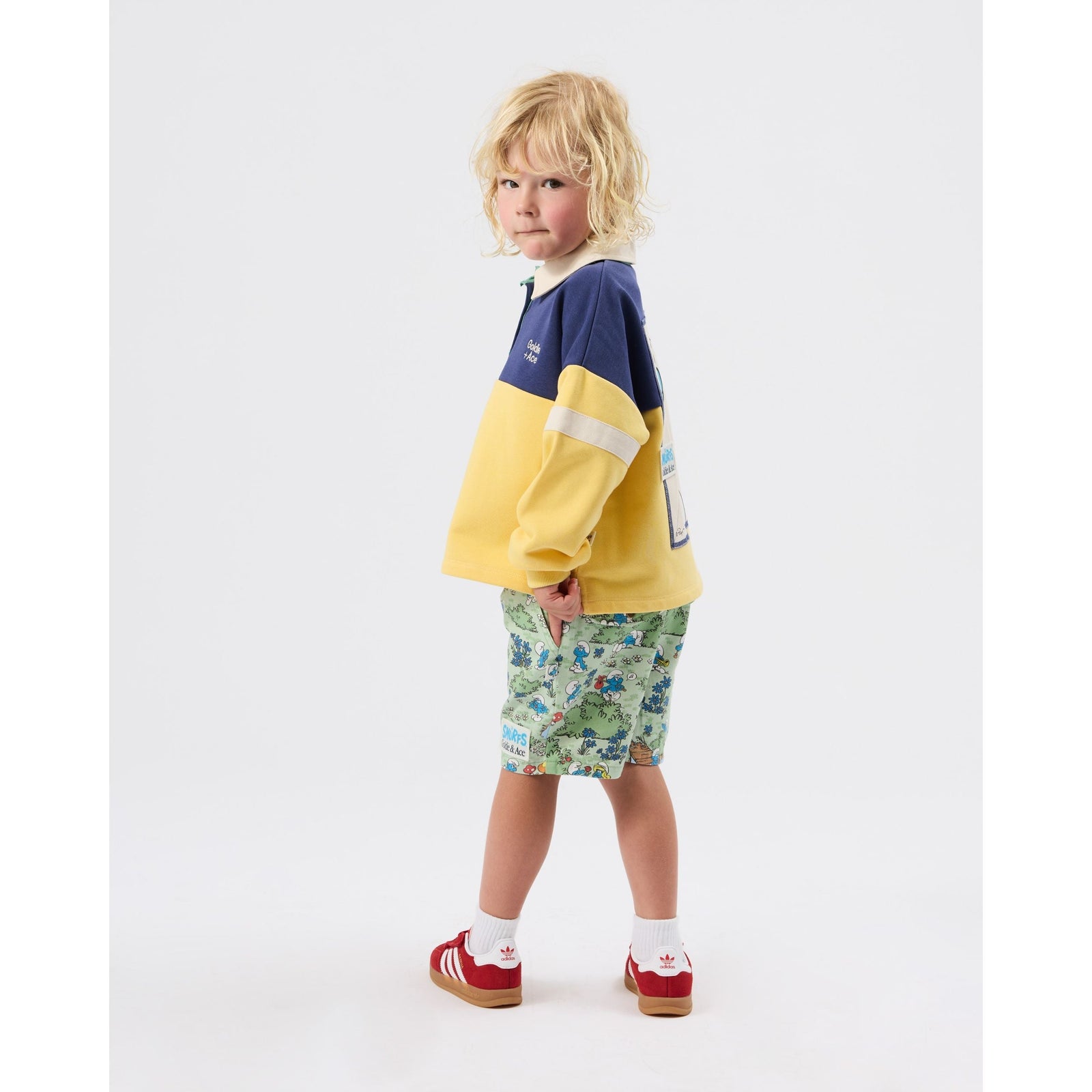 Boy wearing Goldie & Ace x The Smurfs rugby shirt, close up