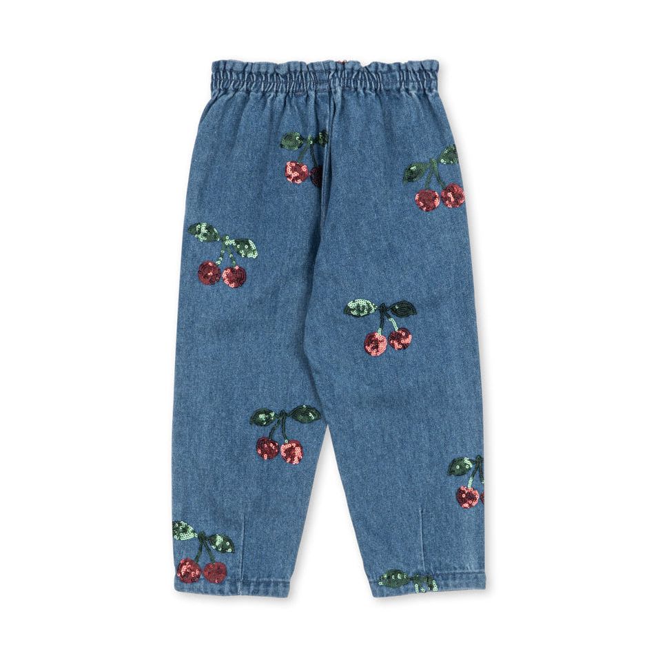 Blue denim pants with an elastic waistband and scattered cherry prints in red and green, shown flat on a white background.